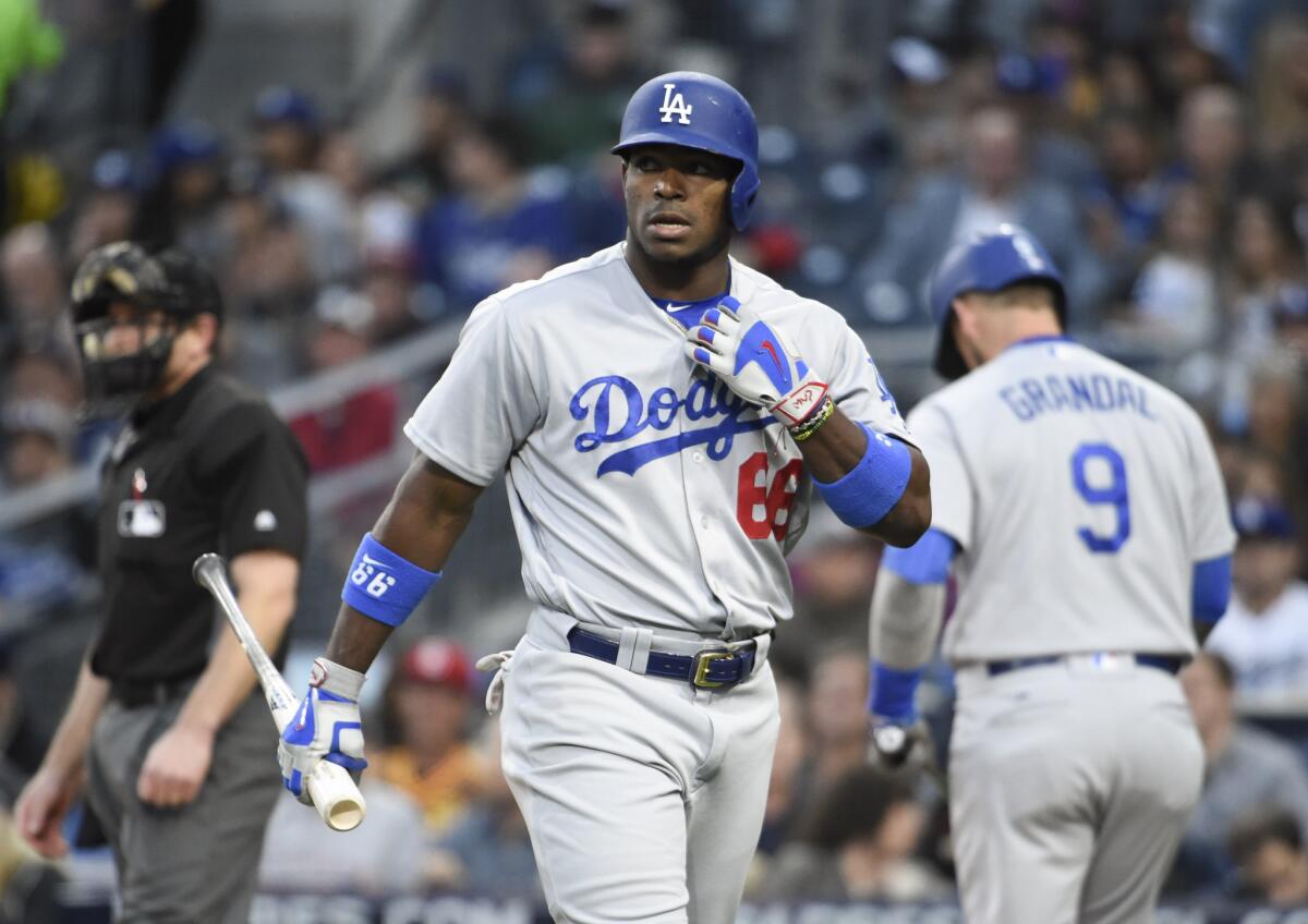 Yasiel Puig returns to the dugout after striking out looking during the second inning against San Diego on May 21.