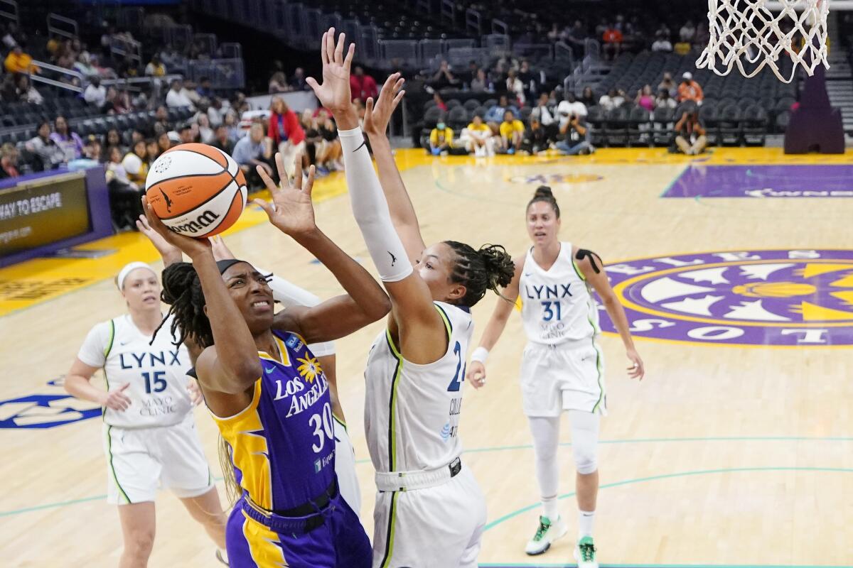 Sparks forward Nneka Ogwumike shoots as Minnesota Lynx forward Napheesa Collier defends.