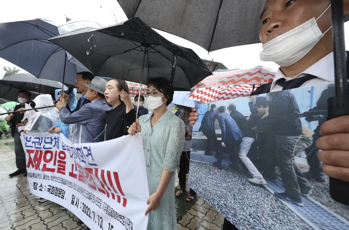 Members of North Korean human rights stage a rally to denounce South Korea's deportation of two North Korean fishermen in 2019, in front of the National Assembly in Seoul, South Korea, Wednesday, July 13, 2022. South Korean prosecutors raided the country’s main spy agency Wednesday as part of investigations into two past North Korea-related incidents that drew criticism that the previous liberal government ignored basic principles of human rights to improve ties with Pyongyang. (Lim Hun-jung/Yonhap via AP)
