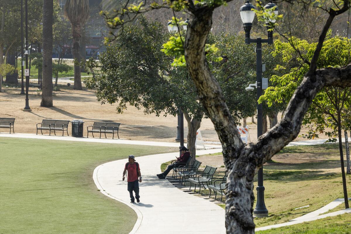 A visitor walks along the path at MacArthur Park.