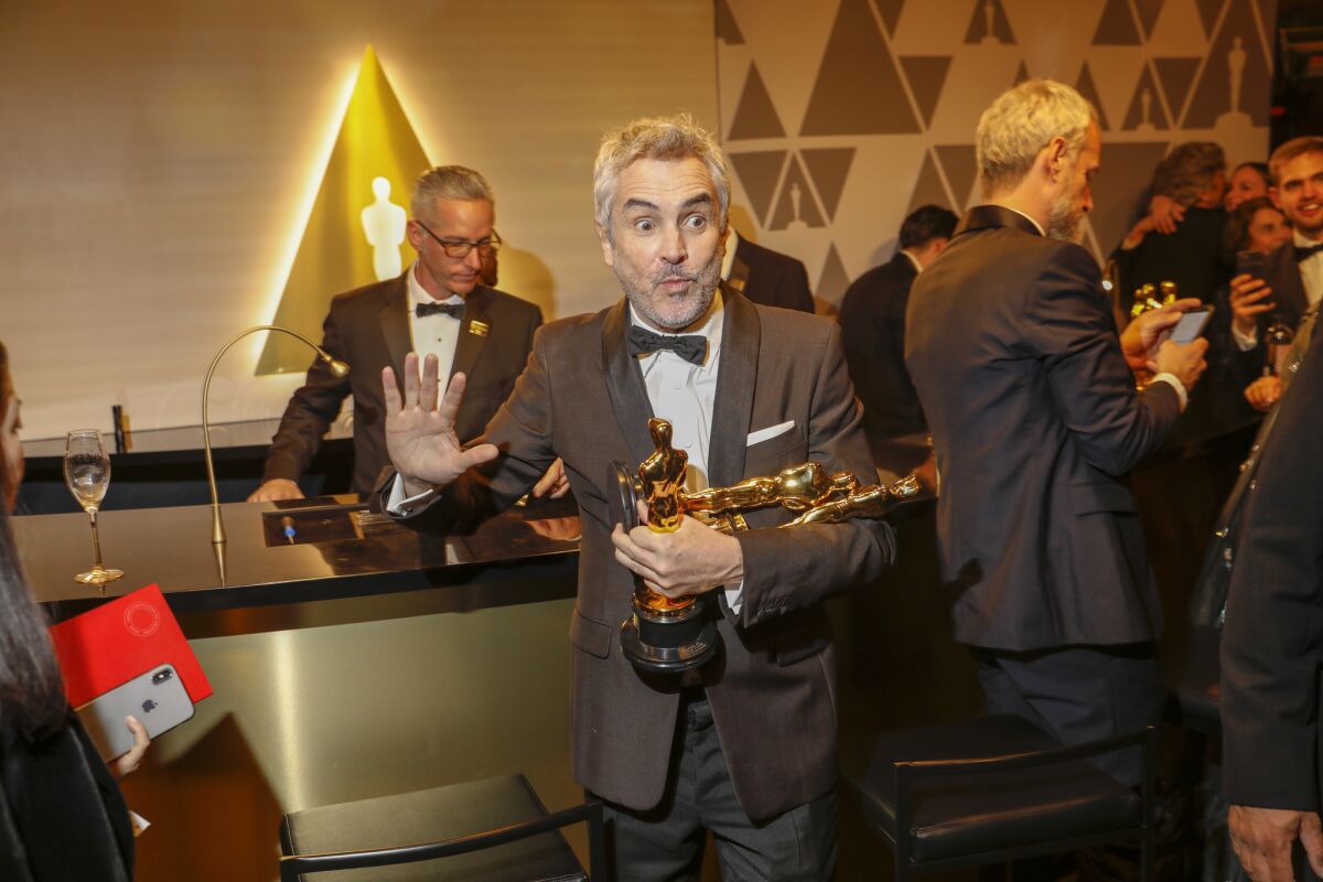 Alfonso Cuarón with his three Oscars at the Academy Awards Governors Ball on Sunday night.