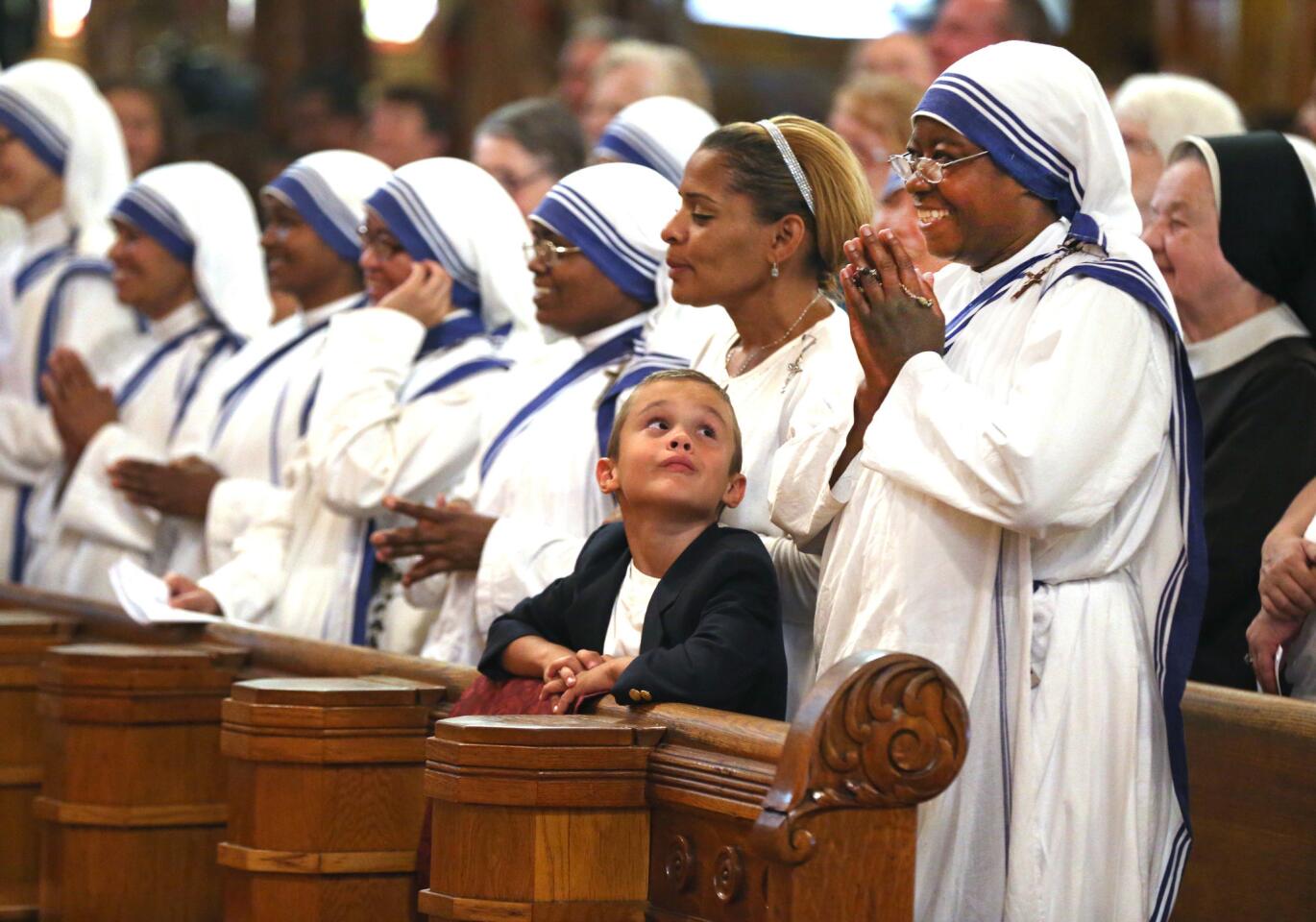 Anthony McElroy, 7, looks up at sister Jesusla of the Missionaries of Charity during a Mass to celebrate the canonization of Mother Teresa at St. John Cantius Parish in Chicago on Sept. 4, 2016.