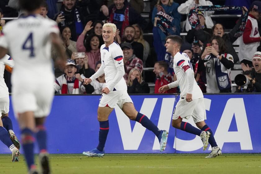 United States midfielder Gio Reyna, center, and forward Christian Pulisic, right, celebrate a goal against Ghana during the first half of an international friendly soccer match Tuesday, Oct. 17, 2023, in Nashville, Tenn. (AP Photo/George Walker IV)