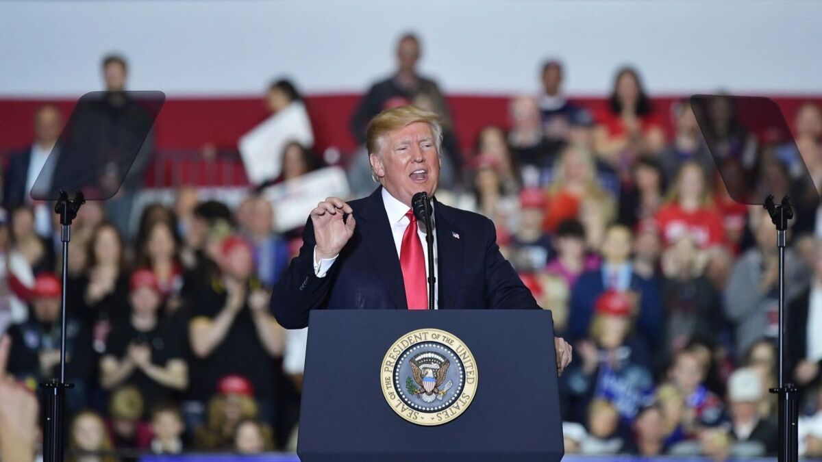 President Trump addresses supporters Saturday at a rally in Washington, Mich.