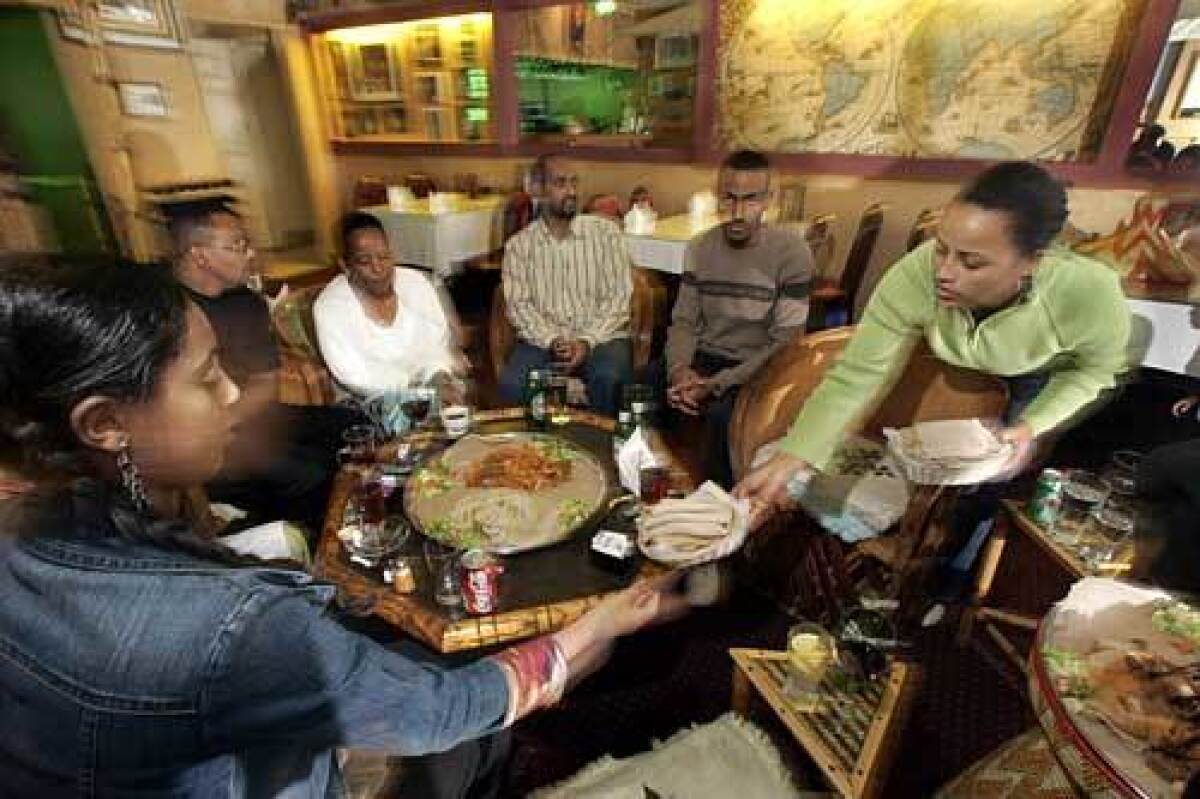 The family of Bernahu Asfaw gathers at his Messob restaurant in the neighborhood dubbed Little Ethiopia.