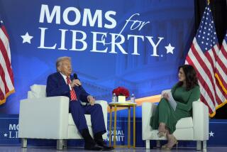 Republican presidential nominee former President Donald Trump speaks with Moms for Liberty co-founder Tiffany Justice during an event at the group's annual convention in Washington, Friday, Aug. 30, 2024. (AP Photo/Mark Schiefelbein)