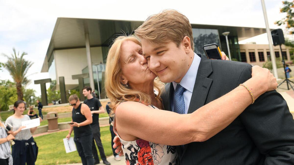 Janowicz is greeted by his mother, Kathy Traverse.