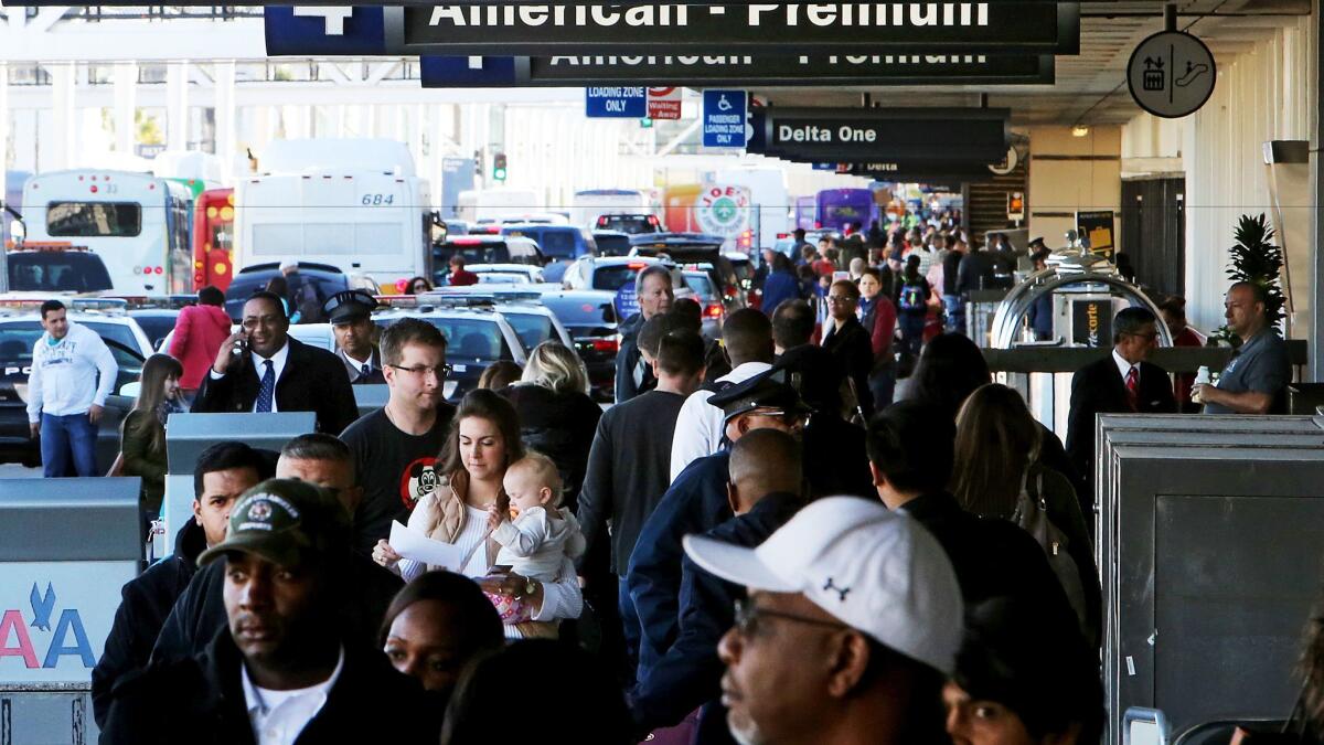 Airline passengers crowd the departure level of LAX on Thanksgiving getaway day, Nov. 25, 2015. The average domestic airfare in the U.S. has dropped 8.5% in 2016, compared to 2015, according to the U.S. Department of Transportation.
