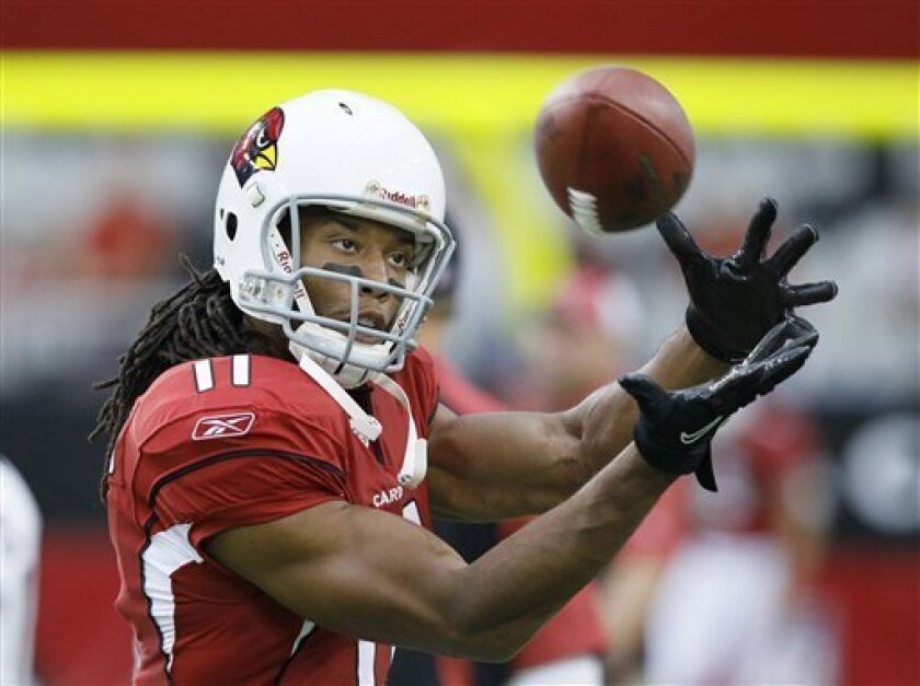 FILE - This Aug. 14, 2010, file photo shows Arizona Cardinals wide receiver Larry Fitzgerald warming up before playing an NFL preseason football game against the Houston Texans, in Glendale, Ariz. Fitzgerald, sidelined with a knee injury most of the pre-season, expects to be back in the lineup when the Cardinals open their regular season Sunday in St. Louis.(AP Photo/Rick Scuteri, File)