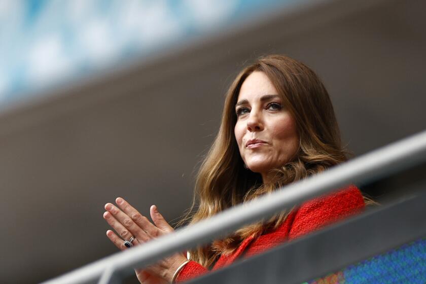 Catherine, Princess of Wales, claps in the stands at a soccer game