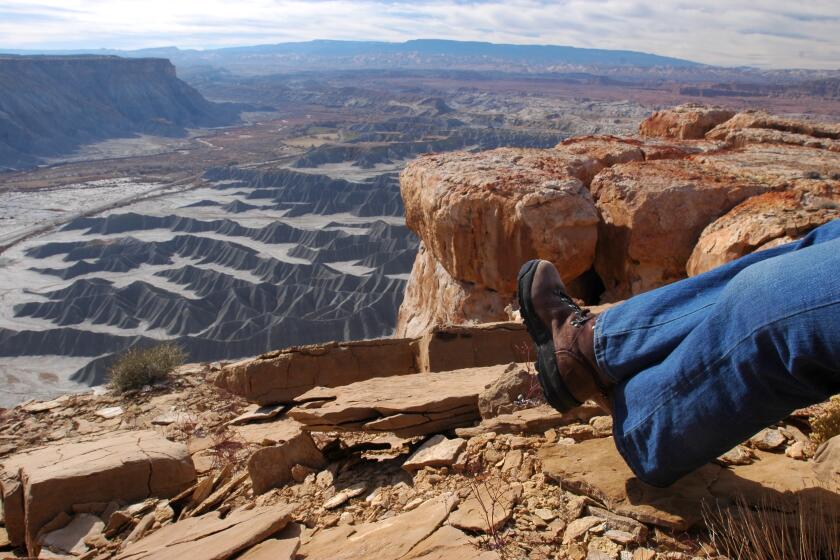 The view from North Caineville Mesa across Mancos shale formation with Capitol Reef National Park in the distance.