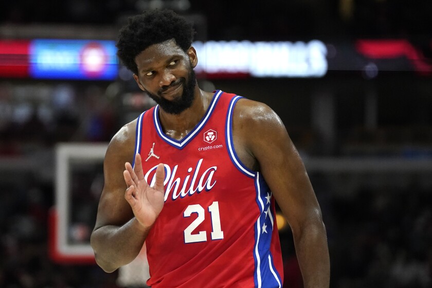 Philadelphia 76ers' Joel Embiid waves to Chicago Bulls fans after hitting a 3-point shot late in the second half of the team's NBA basketball game against the Bulls of Saturday, Nov. 6, 2021, in Chicago. The 76ers won 114-105. (AP Photo/Charles Rex Arbogast)