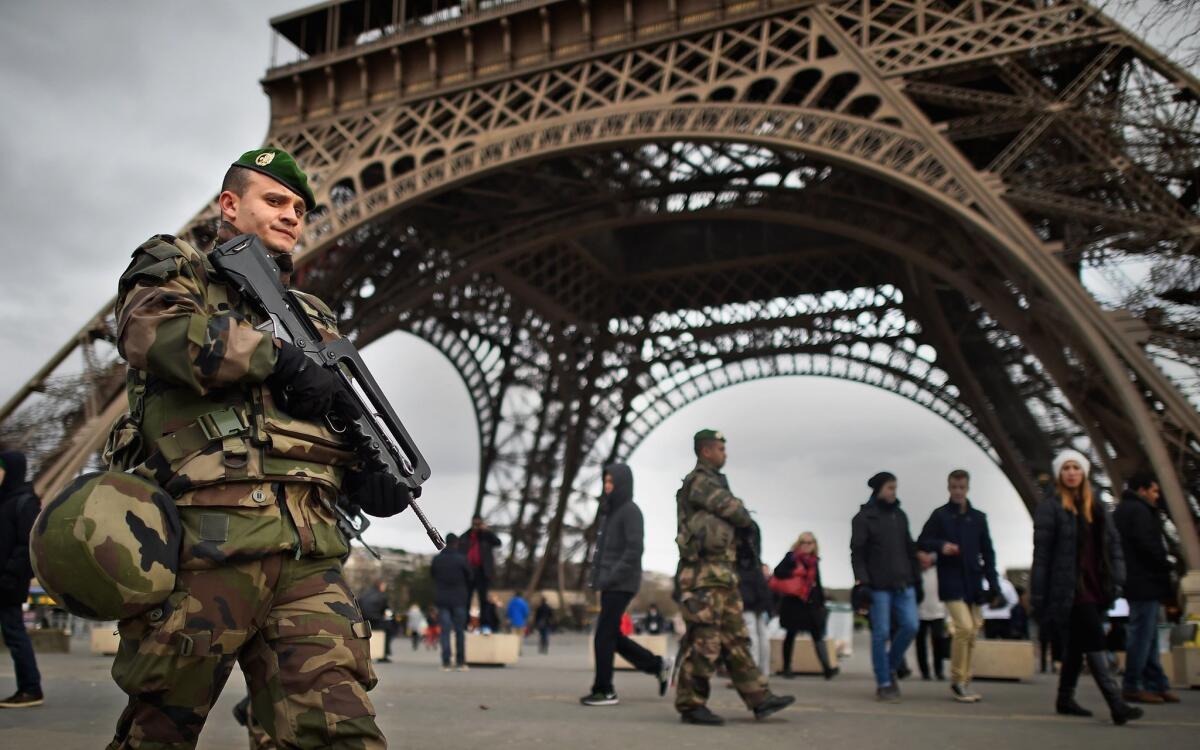 French troops patrol the Eiffel Tower in Paris on Monday.