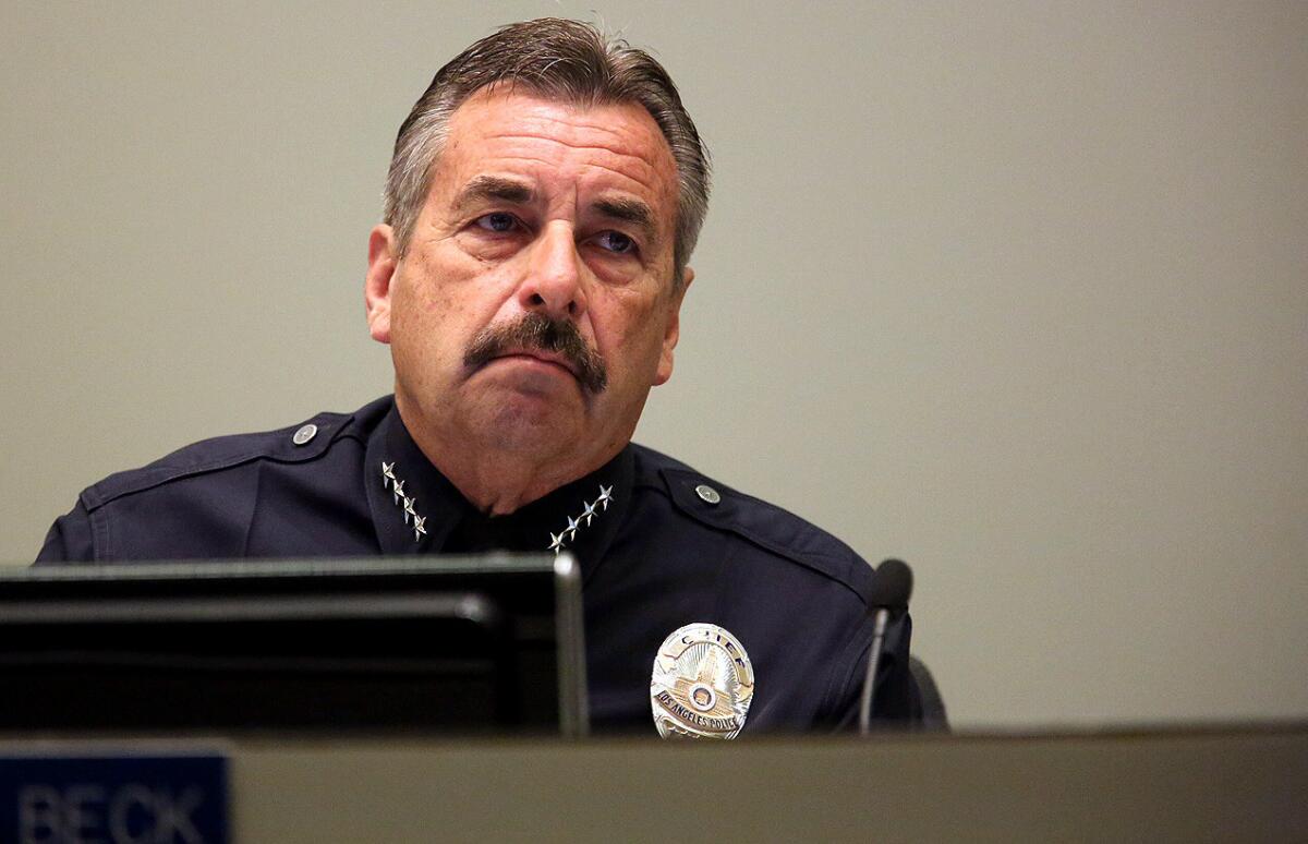 LAPD Chief Charlie Beck listens to public comments inside police headquarters June 9.