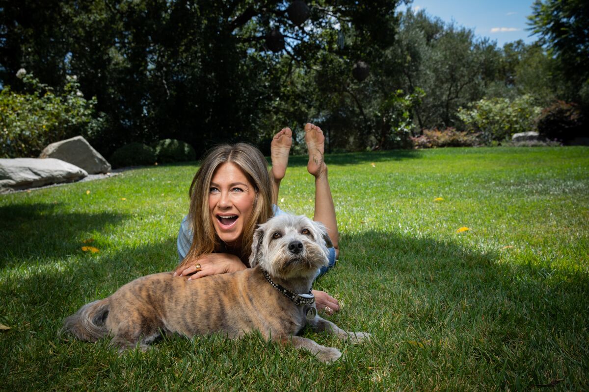 Actress Jennifer Aniston in the backyard of her Los Angeles home, with her dog Clyde, on Wednesday, Aug. 12, 2020.