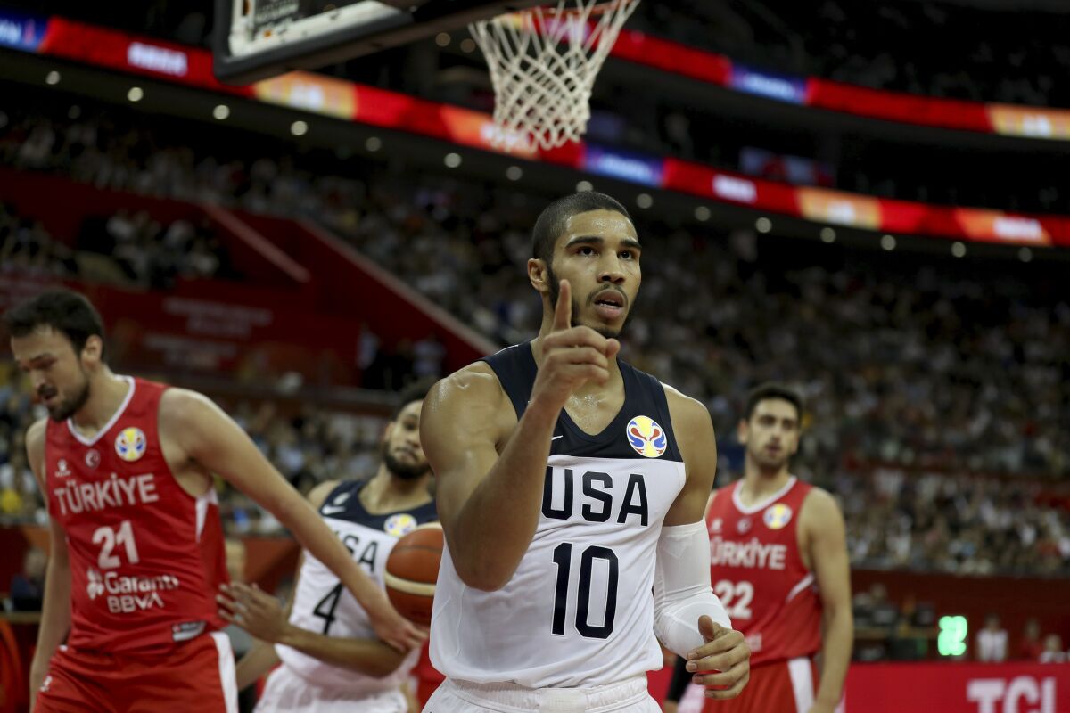 FILE - United States' Jayson Tatum reacts after scoring against Turkey in a FIBA Basketball World Cup basketball game at the Shanghai Oriental Sports Center in Shanghai, in this Tuesday, Sept. 3, 2019, file photo. Kobe Bryant wore No. 24 and No. 8 with the Los Angeles Lakers, but he donned No. 10 for USA Basketball when he helped the Americans capture gold medals at the 2008 and 2012 Olympics. Tatum has worn that number as part of U.S. teams several times since — and will wear it at the Tokyo Olympics, where the Americans will aim to capture a fourth consecutive gold medal. (AP Photo/Ng Han Guan, File)
