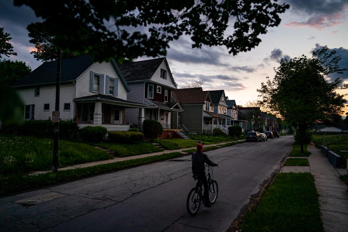 A person rides a bike along a street.