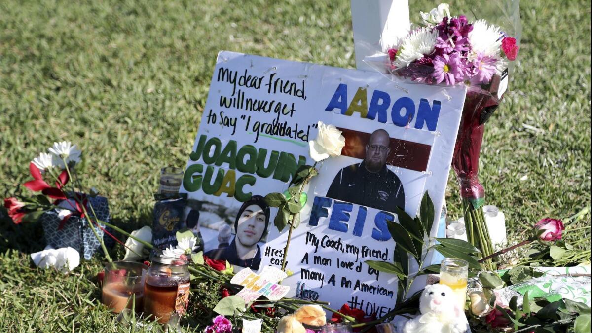 A Feb. 16 tribute to student Joaquin Oliver and coach Aaron Feis at Pine Trails Park in Parkland, Fla. They were killed in the Parkland, Fla., high school shooting two days before.
