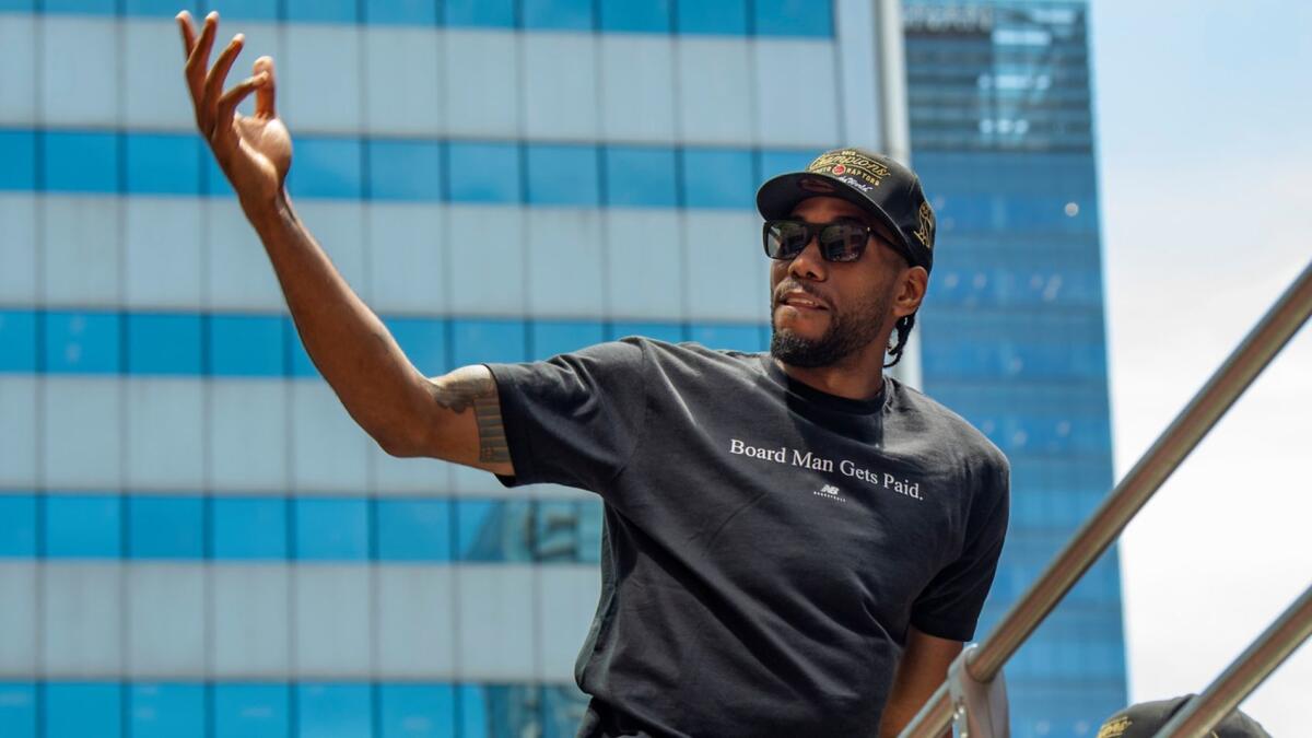 NBA Finals MVP Kawhi Leonard takes part in the victory parade in Toronto after winning the title. Will Leonard join LeBron James and Anthony Davis on the Lakers this season?