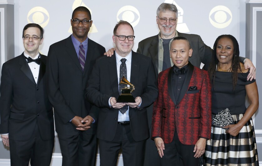 Producers of "The Color Purple," winner of the Grammy for musical theater album, pose for photos after accepting their award Sunday in a pre-telecast ceremony in Los Angeles.