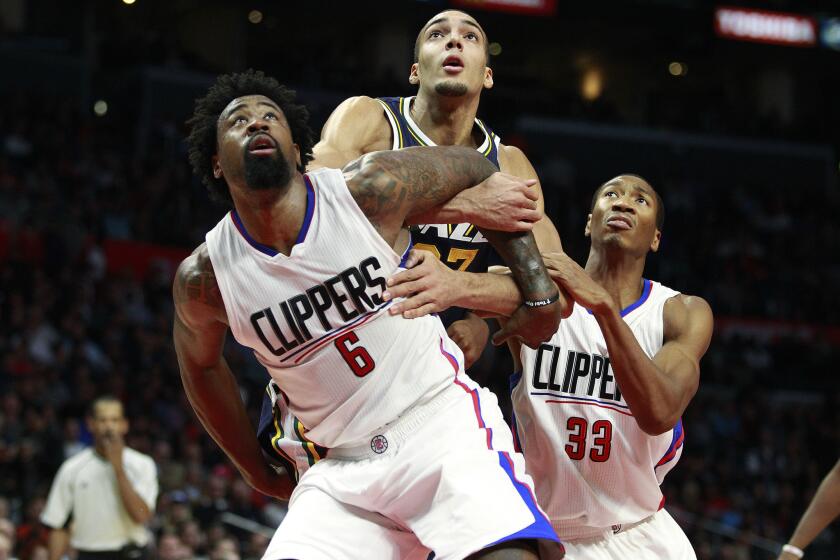 Clippers center DeAndre Jordan (6) and guard Wesley Johnson (33) box out Jazz center Rudy Gobert during a game earlier this season.