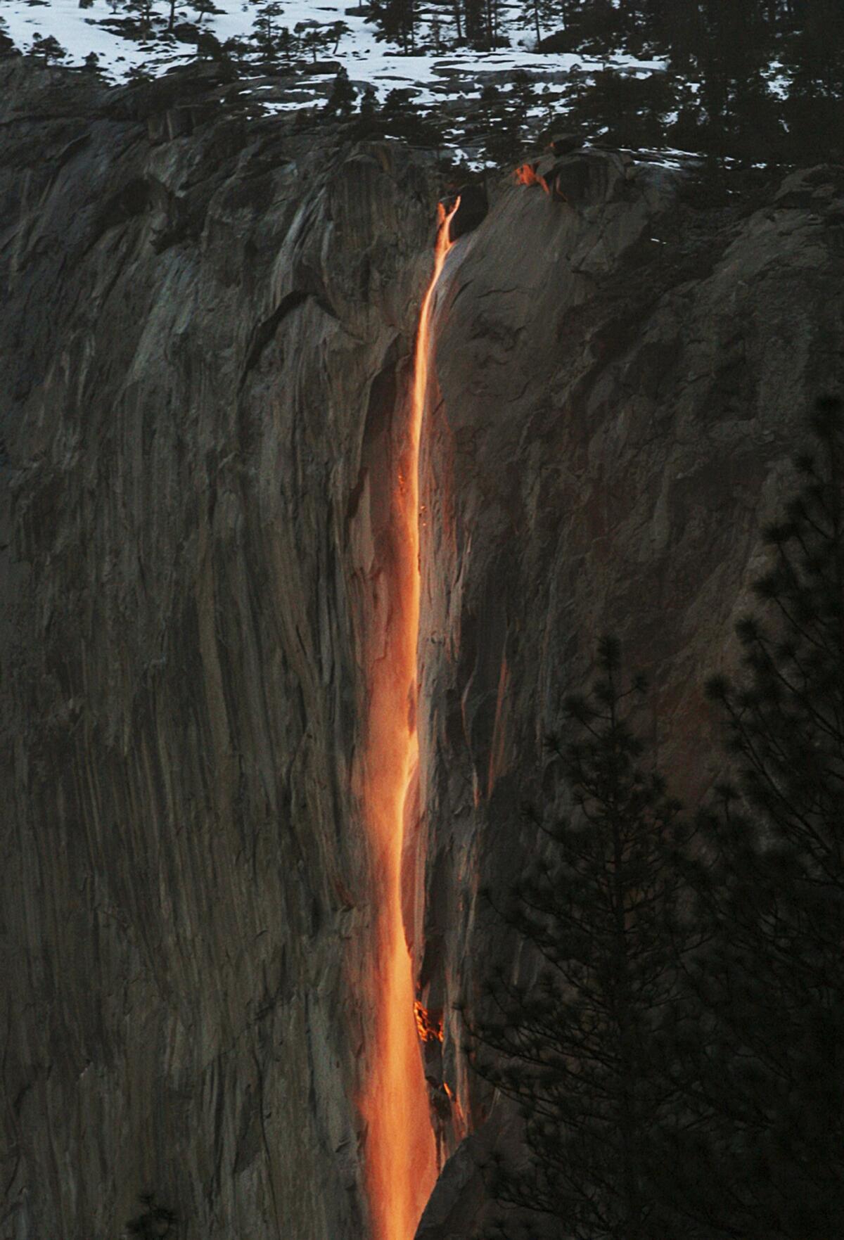 Sunlight creates a glow near Horsetail Fall in Yosemite National Park.