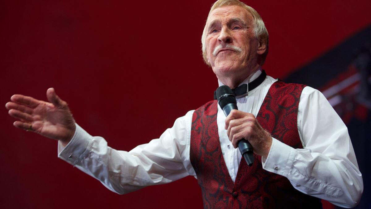 British TV entertainer Bruce Forsyth gestures to the crowd while performing at the Glastonbury Festival of contemporary performing arts in 2013.