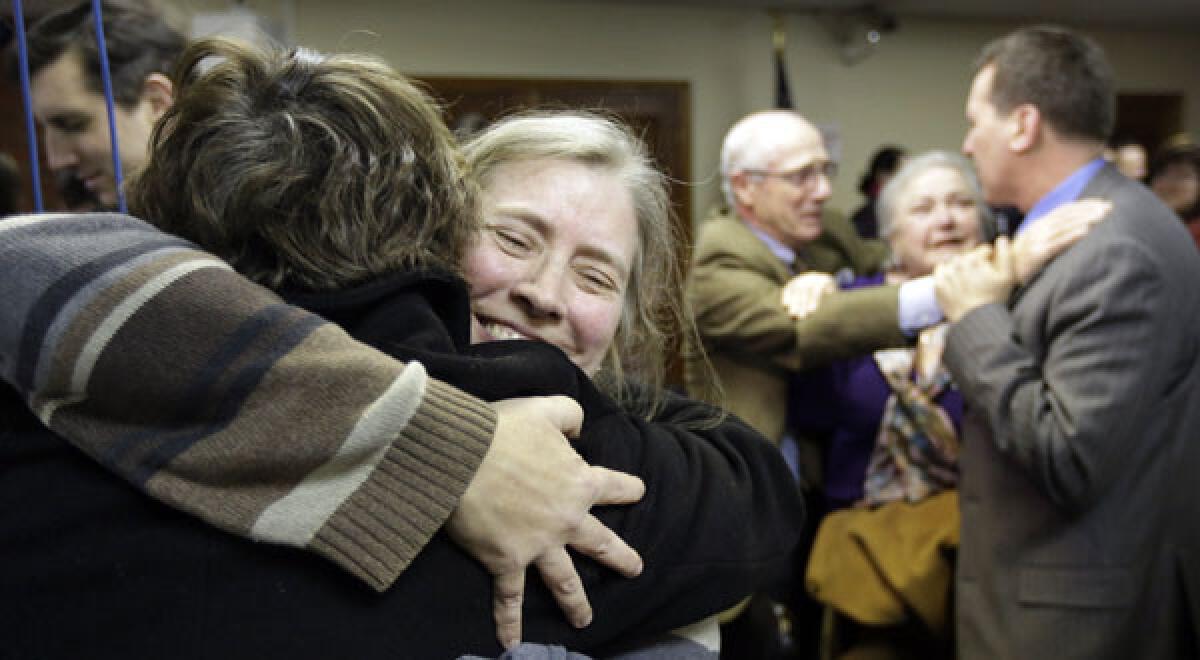 C. Kelly Smith, right, a member of Marriage Equality Rhode Island, hugs fellow member Wendy Becker after a house committee vote on gay marriage.