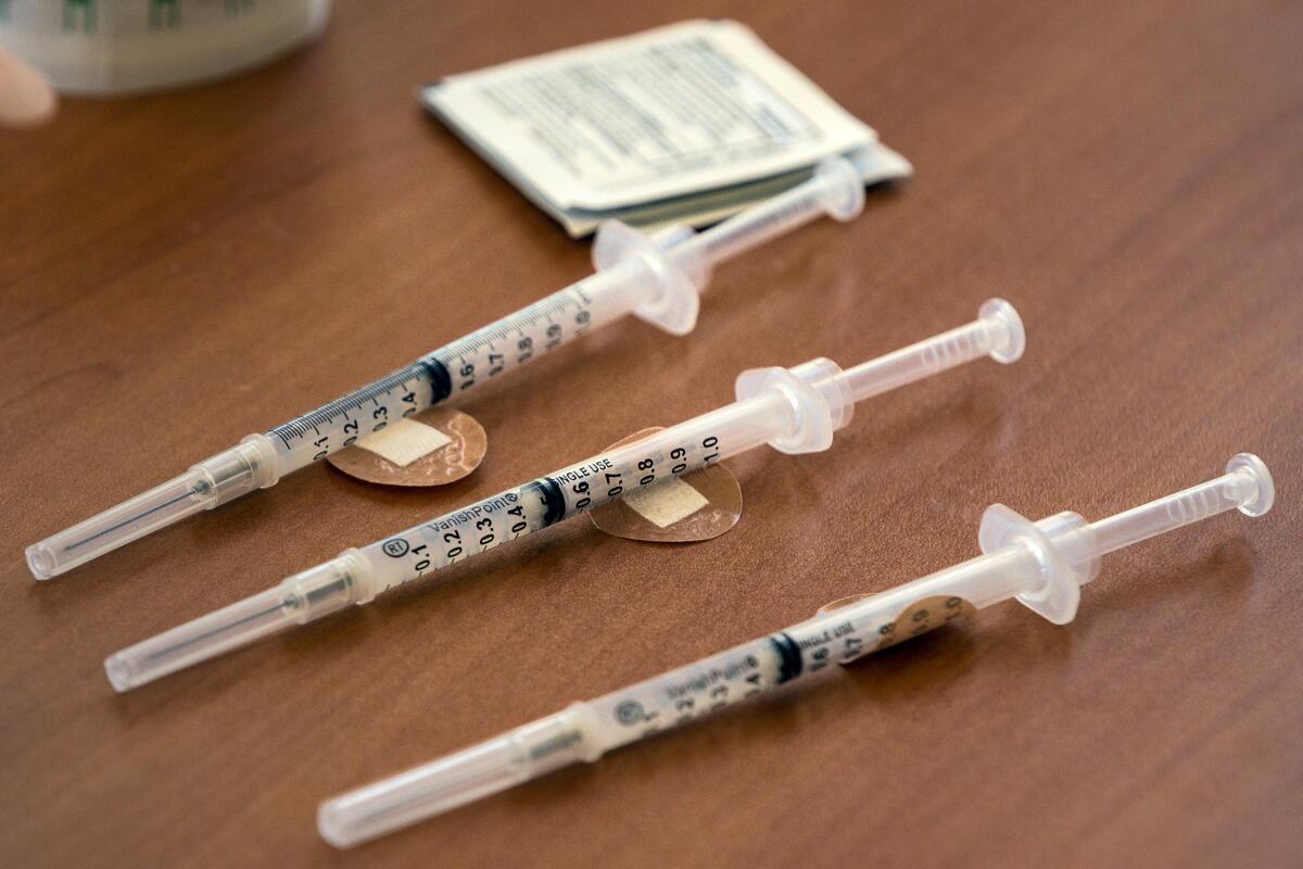 Three syringes with Moderna's COVID-19 vaccine are shown. 