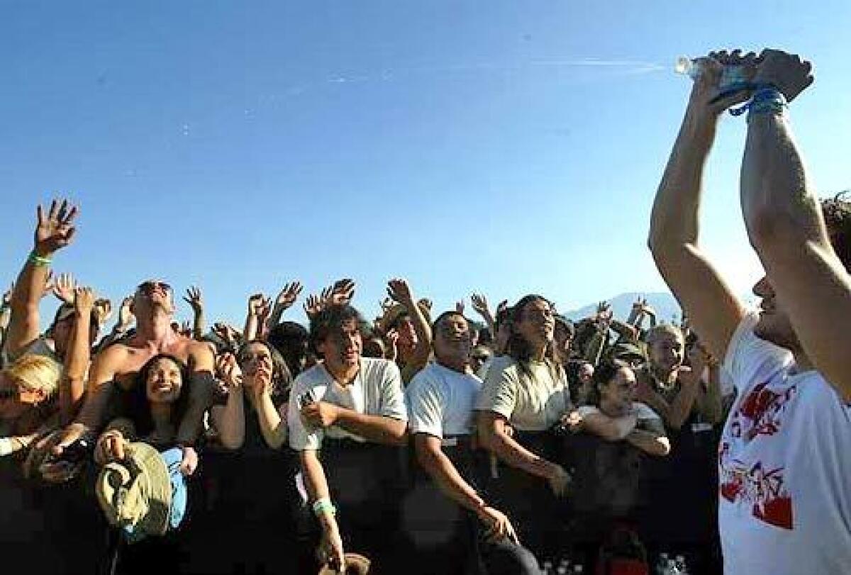 Fans at last years festival get a modicum of relief from the heat. Daytime temperatures are expected to approach 100 degrees this weekend.