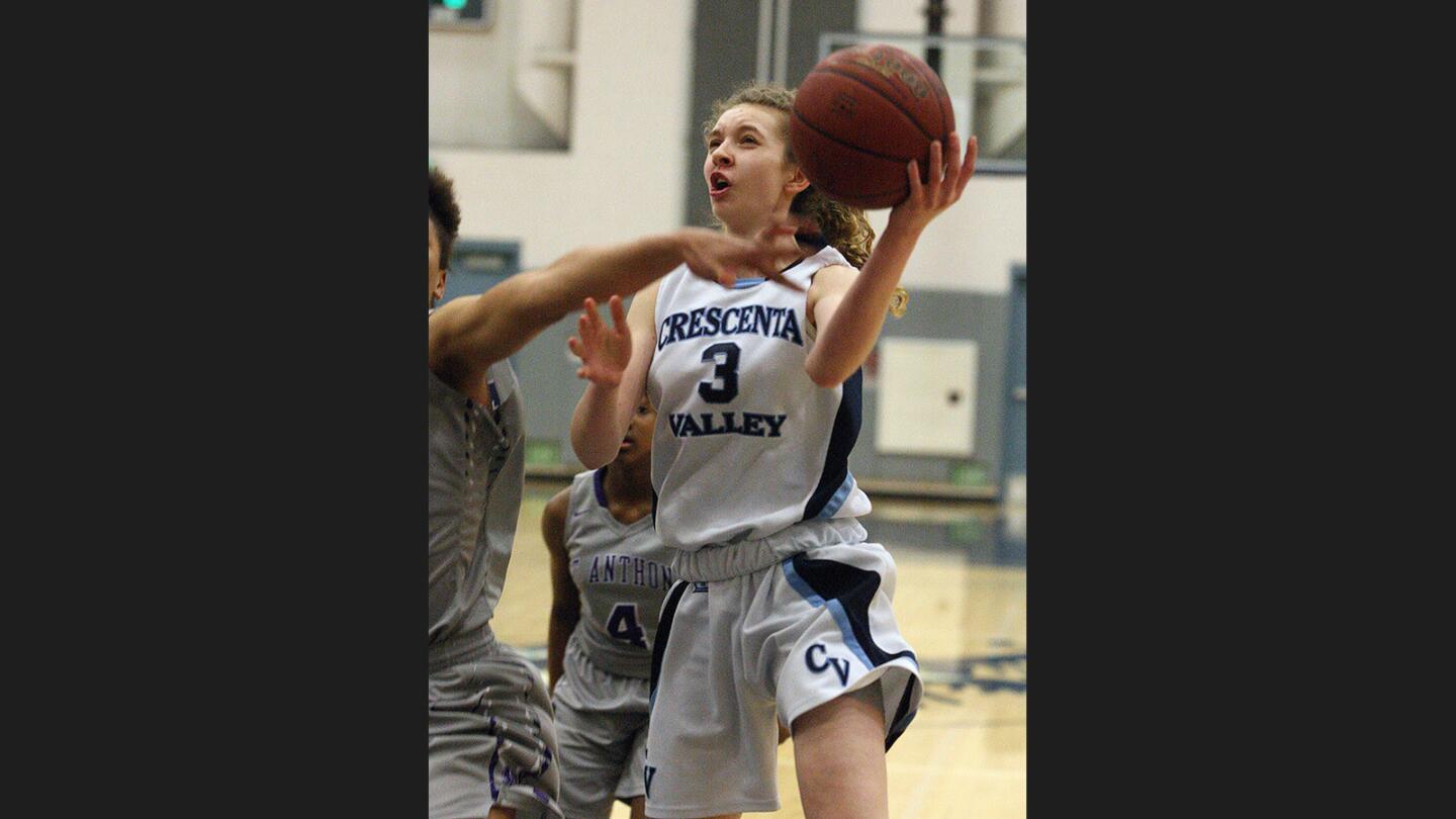 Crescenta Valley's Caity Bouchard drives to the basket and is fouled by Saint Anthony's Semaj Smith on the way by in a CIF Southern Section Division I-AA first-round playoff girls' basketball game at Crescenta Valley High School on Thursday, February 16, 2017.