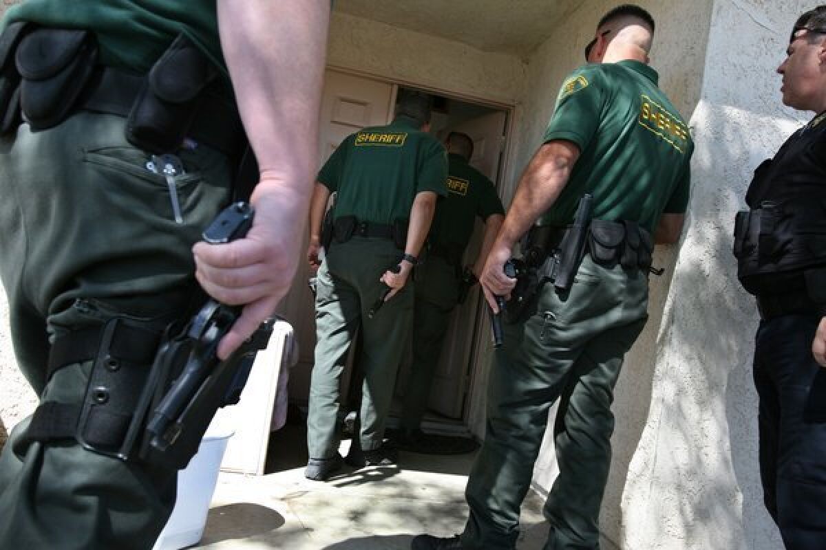 Sheriff's deputies, Los Angeles County Housing Authority investigators and parole agents search Section 8 apartments and homes in March 2007 in Lancaster.