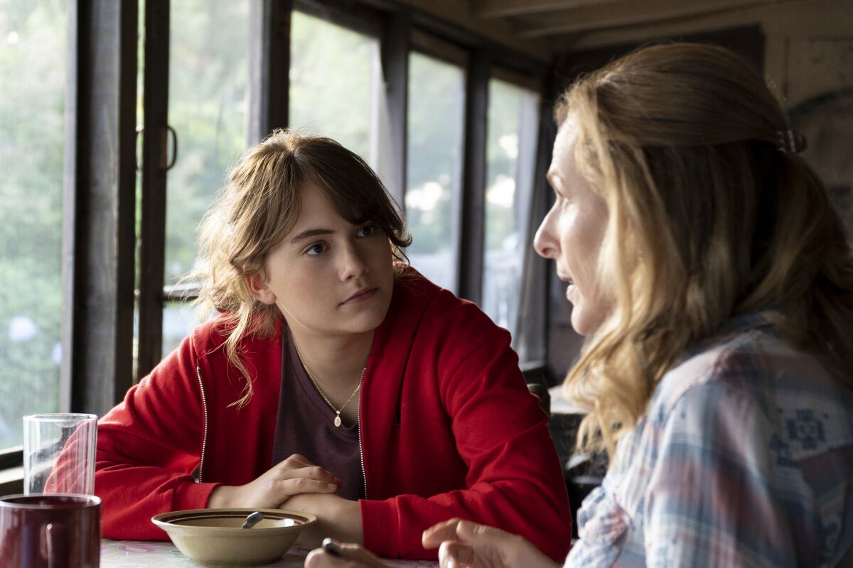 Two women sit at a table in a restaurant.