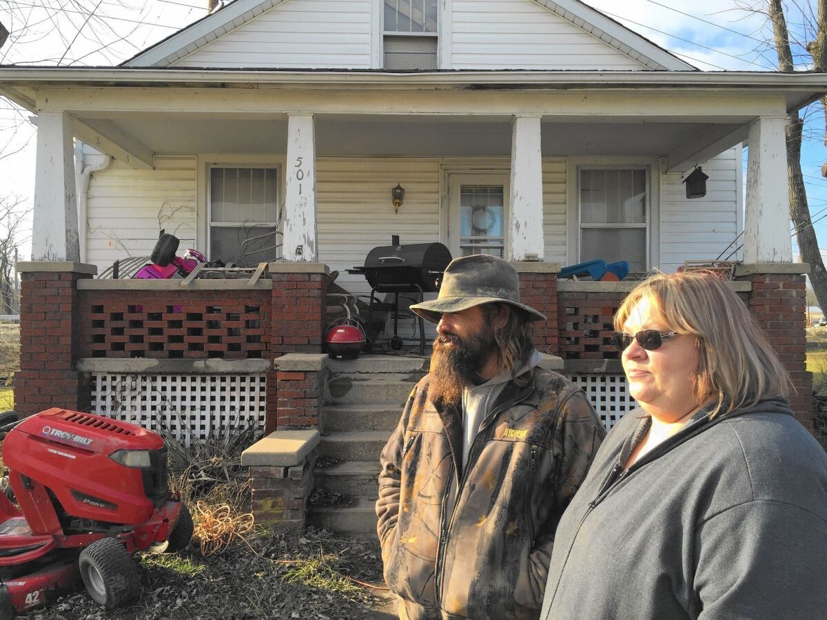 Jim and Kim Hanning inspect the flood damage at their home in Union, Mo.