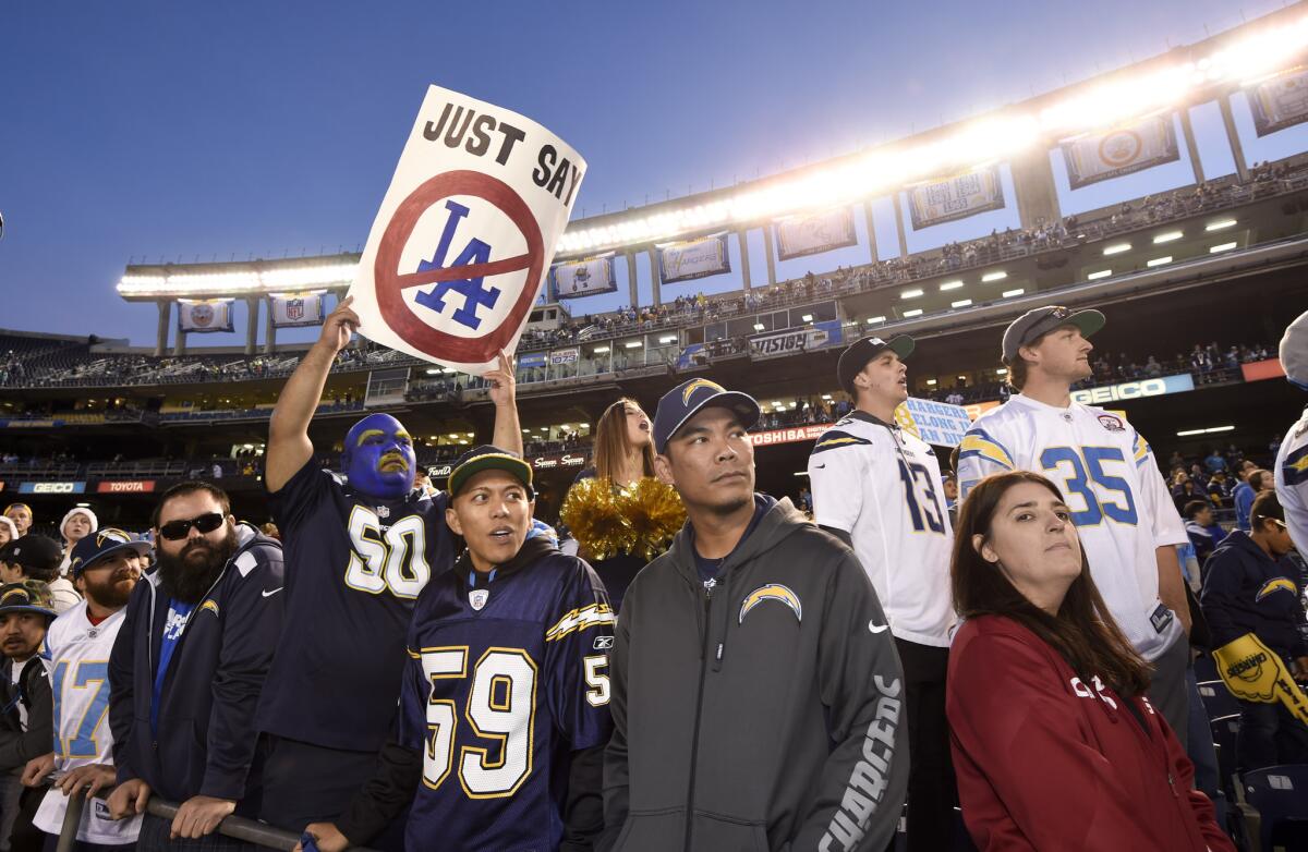 A fan holds up a sign commenting on the possible move by the San Diego Chargers during an NFL football game against the Miami Dolphins Sunday, Dec. 20, 2015, in San Diego. (AP Photo/Denis Poroy)