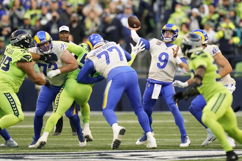 Los Angeles Rams quarterback Matthew Stafford (9) passes against the Seattle Seahawks during the first half of an NFL football game, Thursday, Oct. 7, 2021, in Seattle. (AP Photo/Elaine Thompson)