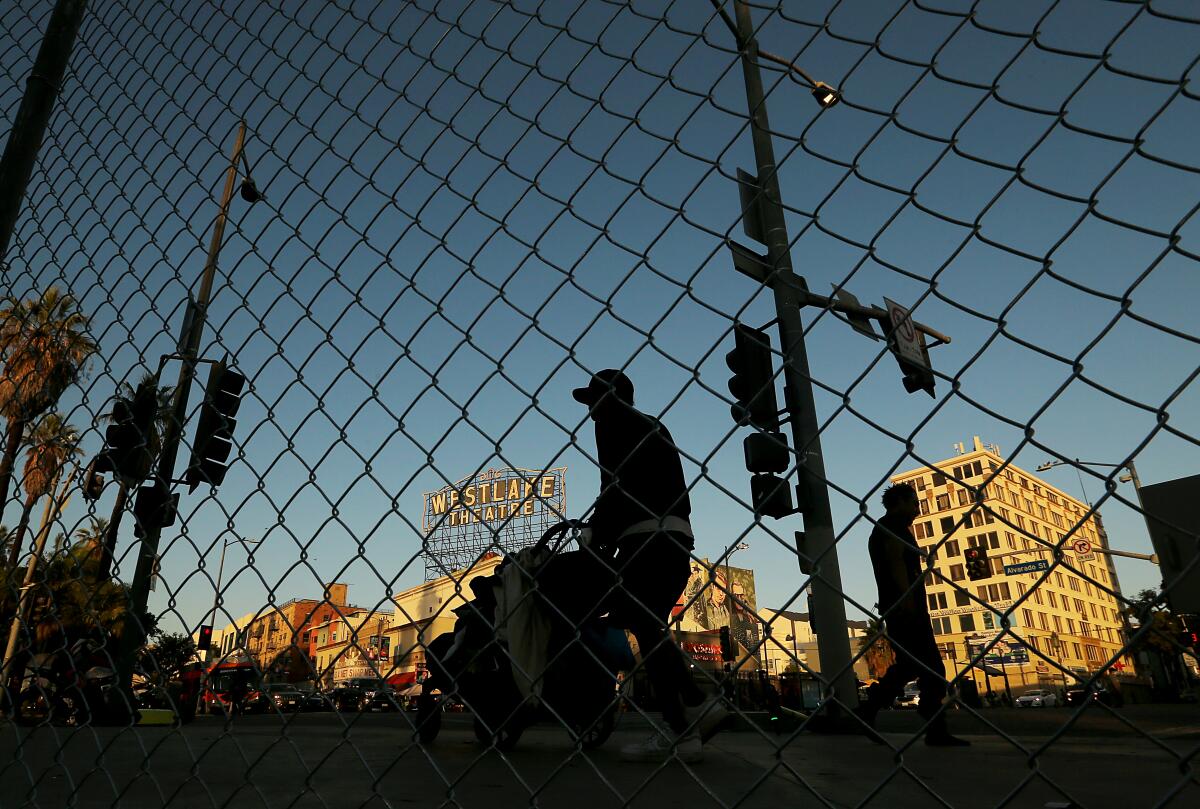 A homeless encampment was cleared and a chain-link fence erected around MacArthur Park in Los Angeles on Friday.