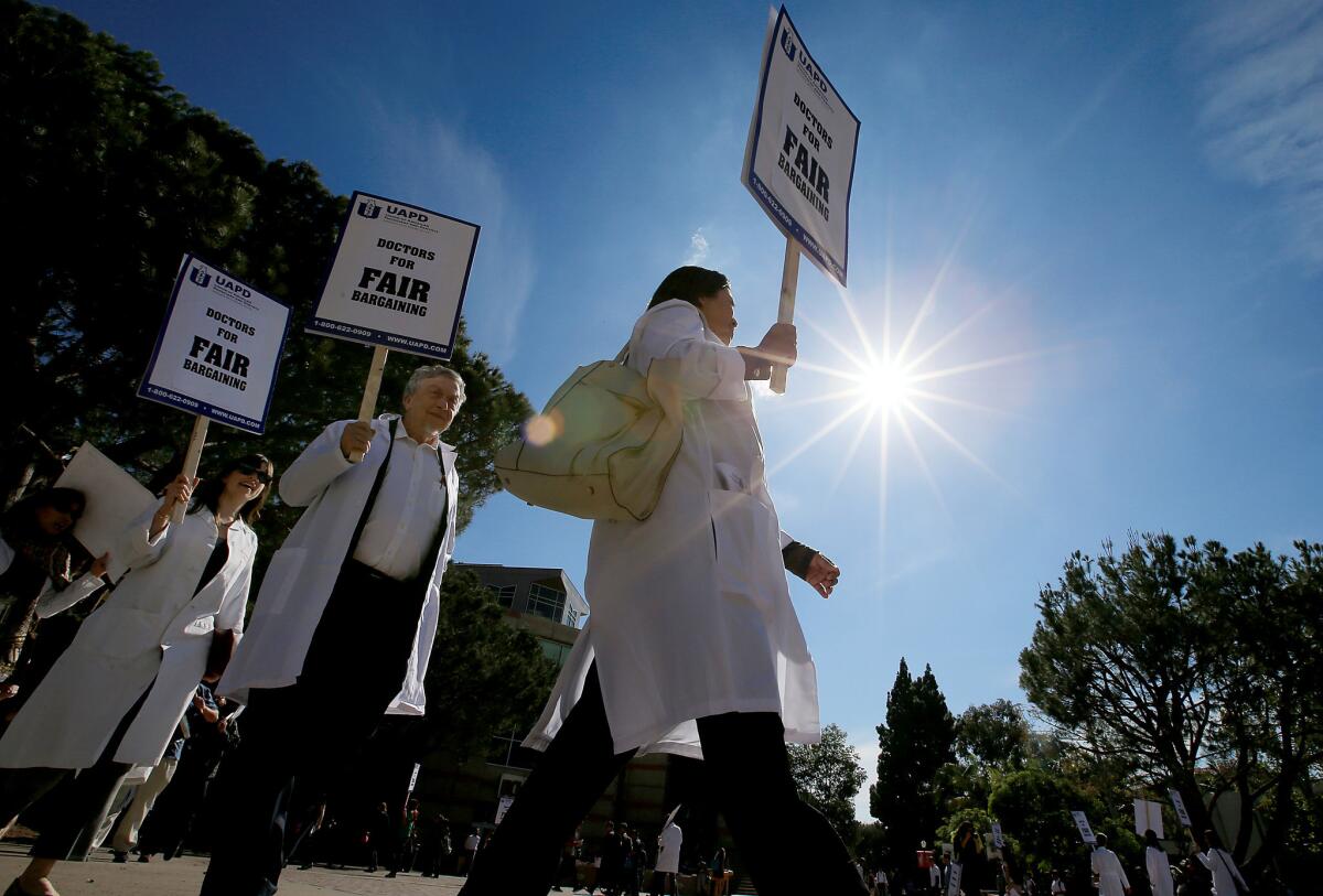 Unionized doctors, support personnel and students picket and rally to protest what they say are unfair labor practices at UC student health centers on the campus of UCLA in Westwood.