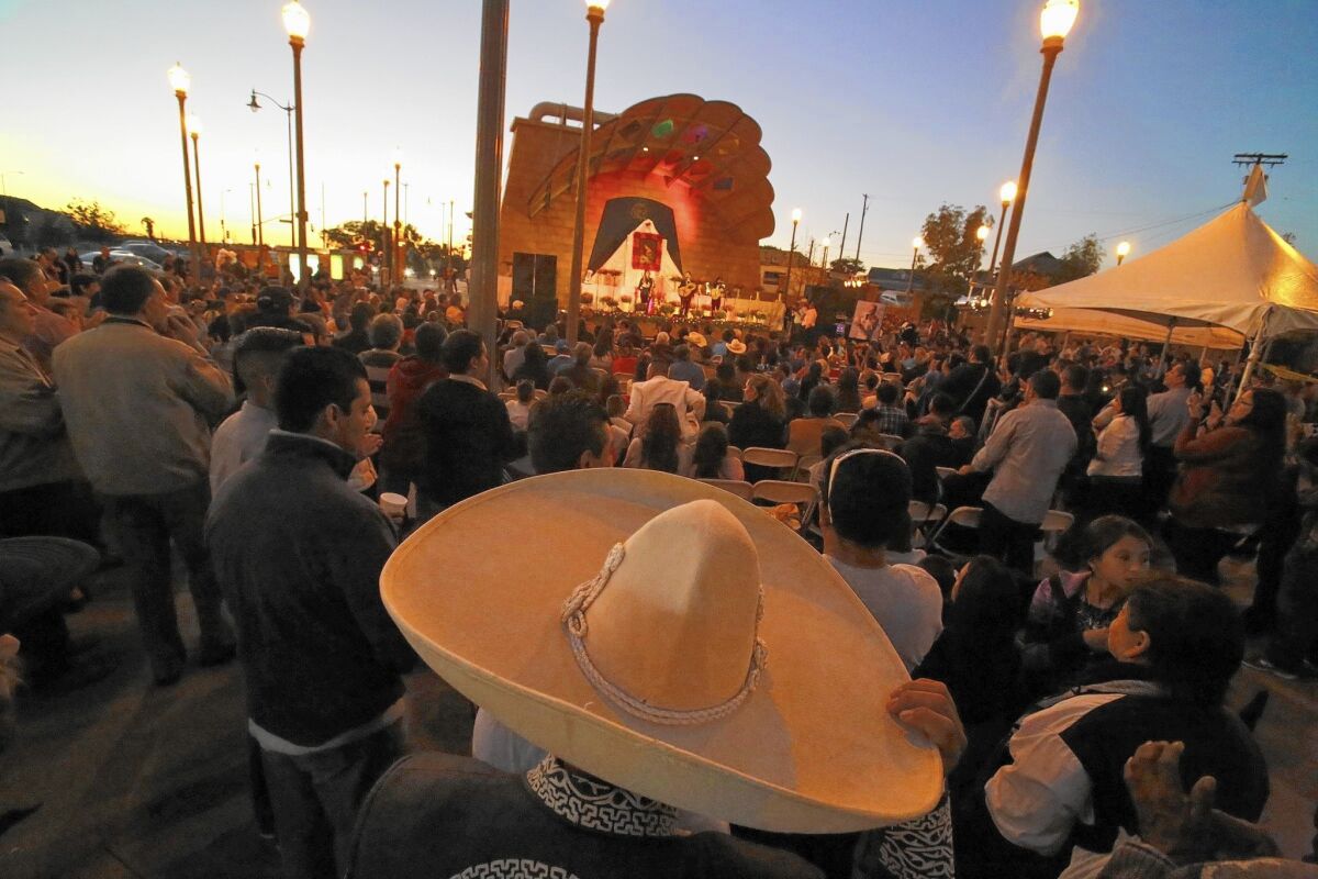 A crowd gathers for a festival honoring St. Cecilia at Mariachi Plaza in Boyle Heights. A plan to turn the plaza into a modern shopping center has the community worried about the effects on the mariachis.