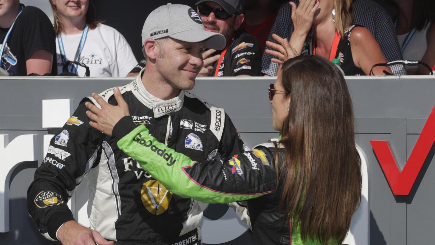 Ed Carpenter is hugged by Danica Patrick after he won the pole position during qualifying for the Indianapolis 500 on May 20, 2018. Carpenter's team also prepared the car Patrick is driving.