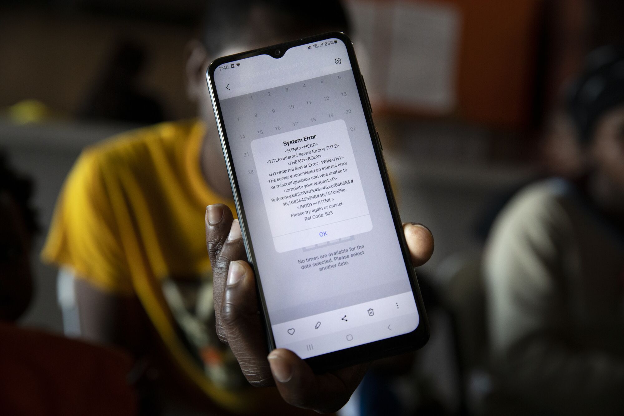 A man displays an error message from CBP One at Espacio Migrante on Wednesday in Tijuana.