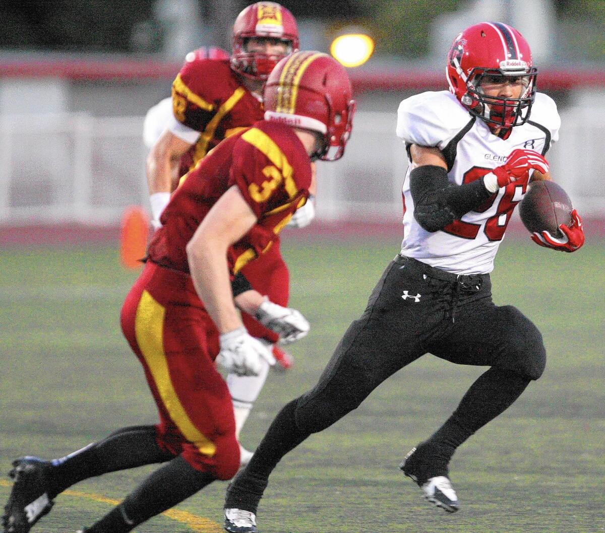 Glendale Daniel Jung runs the ball with La Cañada's Andrew Gunter defending during a game on Friday, September 12, 2014.