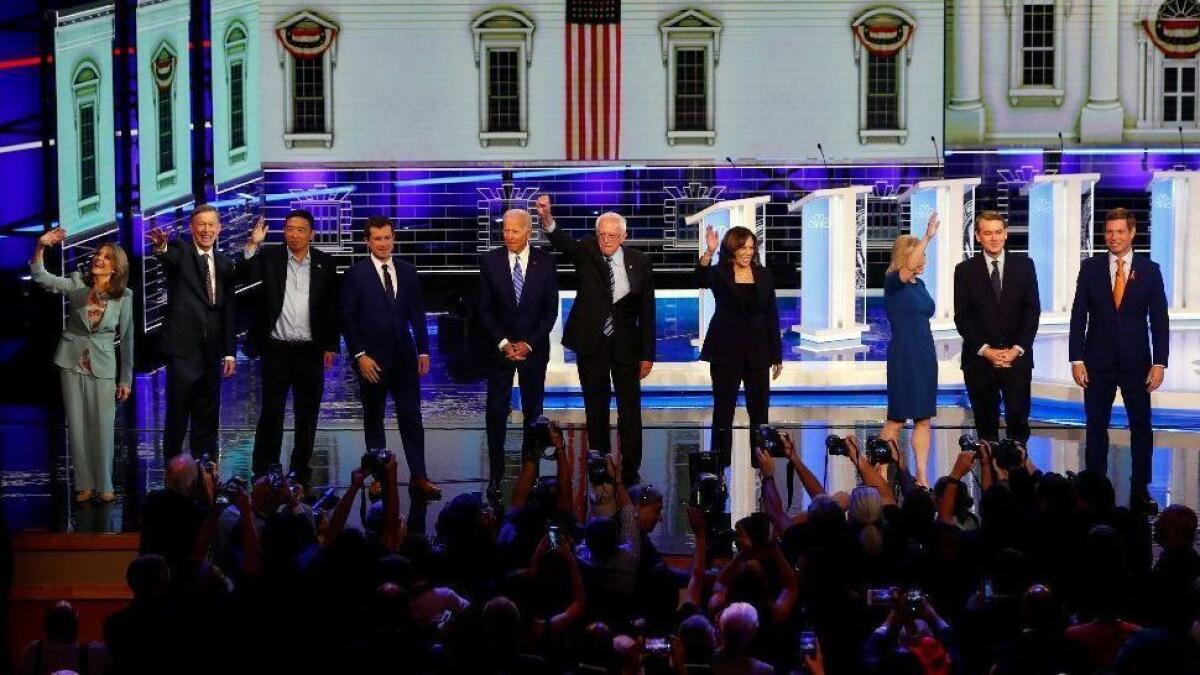 Ten of the Democratic presidential candidates stand on the stage before the second night of debates in Miami on Thursday.