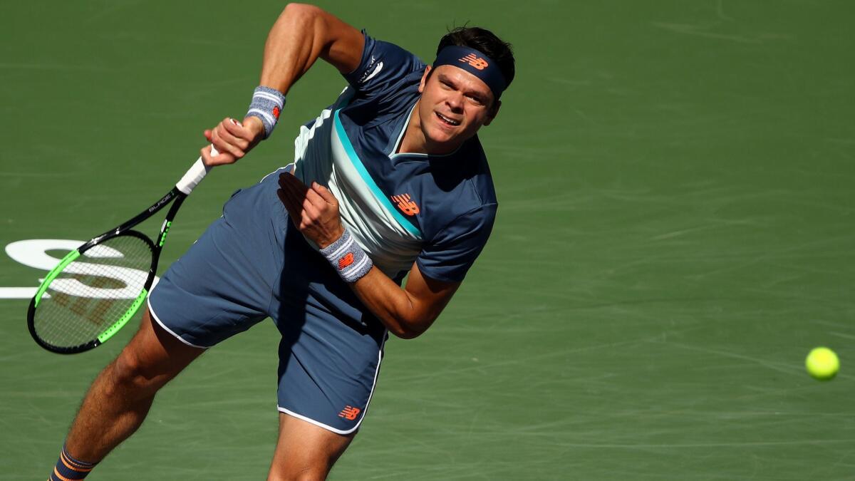 Milos Raonic serves against Miomir Kecmanovic during their men’s singles quarterfinal match at the BNP Paribas Open at the Indian Wells Tennis Garden on Thursday.