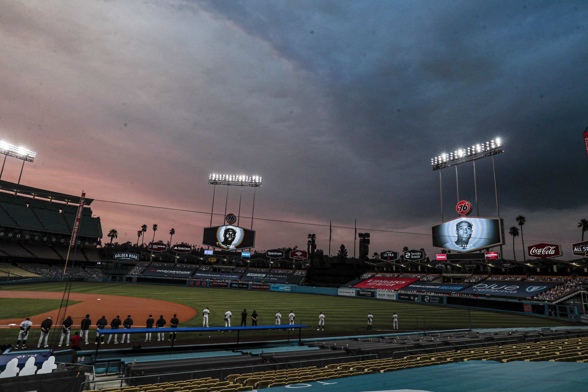 Smoke from two area fires fills the sunset sky before the Dodgers play the Rockies at Dodger Stadium.