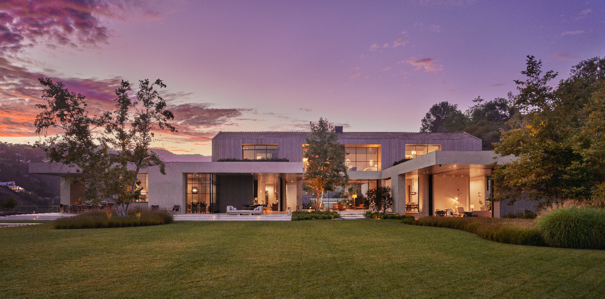 The exterior of a sleek, two-story modern mansion with large windows.