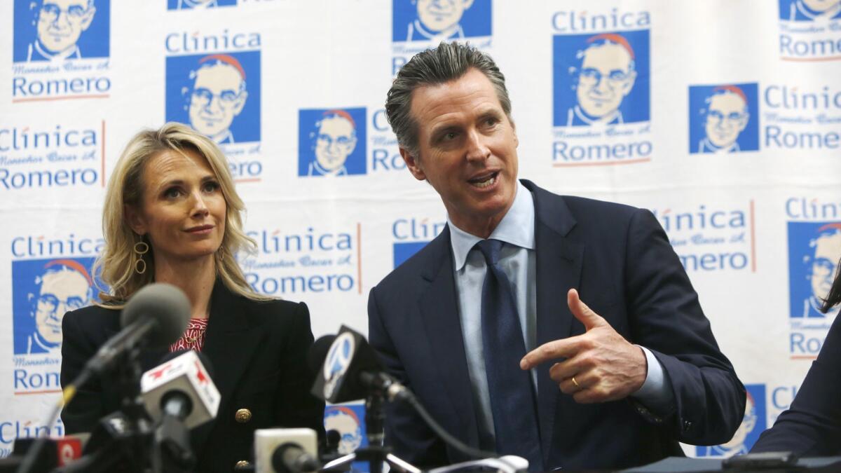 Gov. Gavin Newsom with his wife, Jennifer Siebel Newsom, during a discussion at the Clinica Monse?or Oscar A. Romero facility about Central American migration.