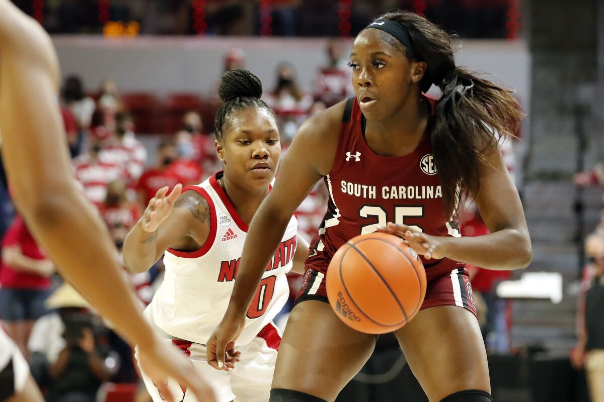 South Carolina's Raven Johnson (25) looks to pass the ball against North Carolina State during the first half of an NCAA college basketball game, Tuesday, Nov. 9, 2021, in Raleigh, N.C. (AP Photo/Karl B. DeBlaker)
