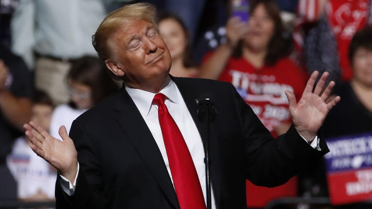 President Donald Trump sways to the playing of West Virginia's state song as he takes the stage during a rally in Wheeling, W.Va., on Saturday.