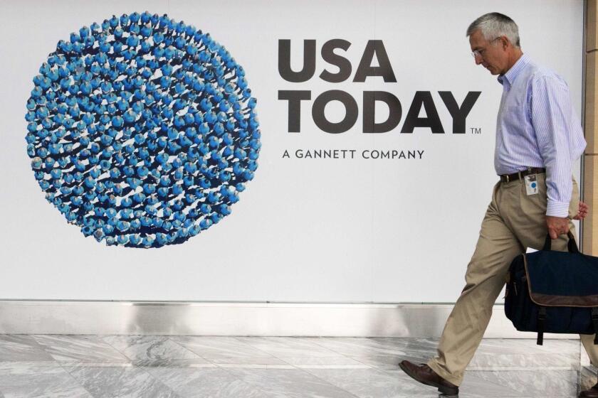 (FILES) This file photo taken on August 20, 2013 shows a man walking through the lobby of the Gannett-USA Today headquarters building in McLean, Virginia. USA Today publisher Gannett announced November 1, 2016 it was ending its bid for Los Angeles Times owner Tronc, a deal which would have created a powerhouse in the newspaper sector. Months after its offer for the newspaper rival was announced in April, Gannett said in a brief statement it "has determined not to pursue an acquisition of Tronc," without elaborating.Gannett had initially offered $815 million for the group formerly known as Tribune Publishing, which also publishes the Chicago Tribune, Baltimore Sun and other dailies. / AFP PHOTO / PAUL J. RICHARDSPAUL J. RICHARDS/AFP/Getty Images ** OUTS - ELSENT, FPG, CM - OUTS * NM, PH, VA if sourced by CT, LA or MoD **